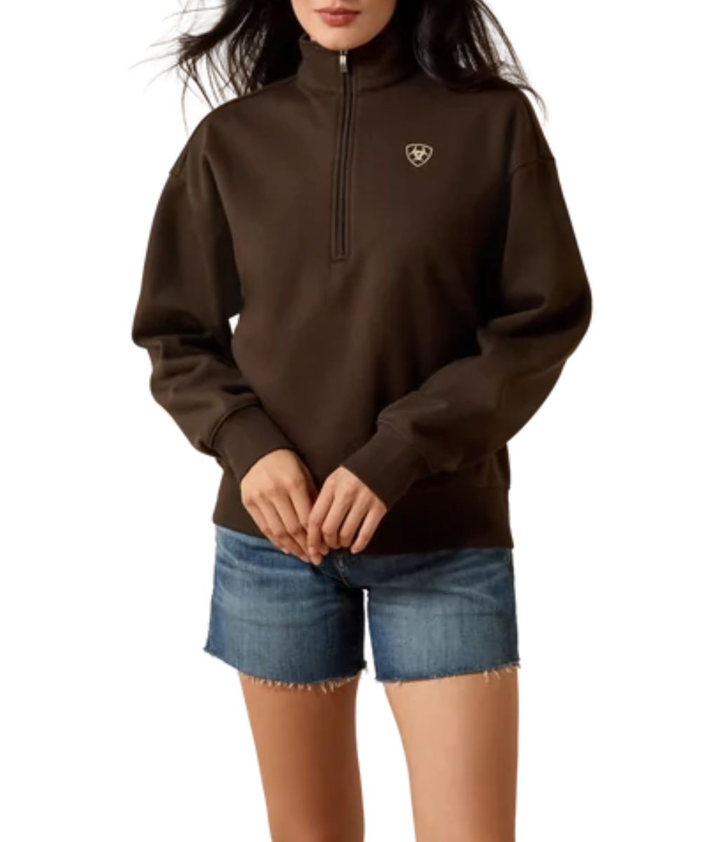 Front view of the women's brown/delicioso Ariat long sleeve pullover sweatshirt featuring the 1/2 zip closure, mock neck, easy fit, and Ariat Shield logo embroidery at the left chest