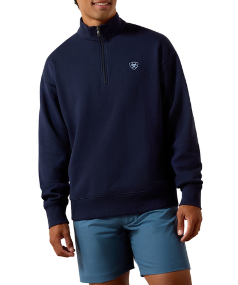Front view of the men's navy Ariat long sleeve pullover sweatshirt featuring the 1/4 zip closure, mock neck, easy fit, and small Ariat Shield logo embroidery at the left chest