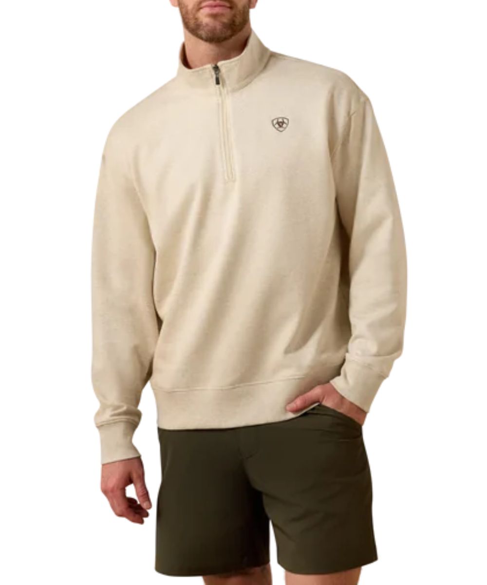 Front view of the men's oatmeal heather Ariat long sleeve pullover sweatshirt featuring the mock collar, 1/4 zip closure, and the small Ariat Shield logo embroidered at the left chest