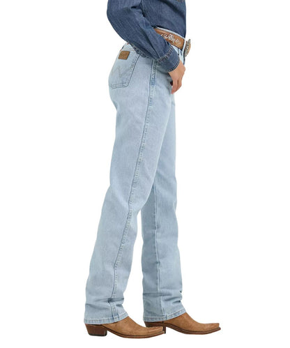 Side view of the women's cowboy cut Wrangler bleach jean