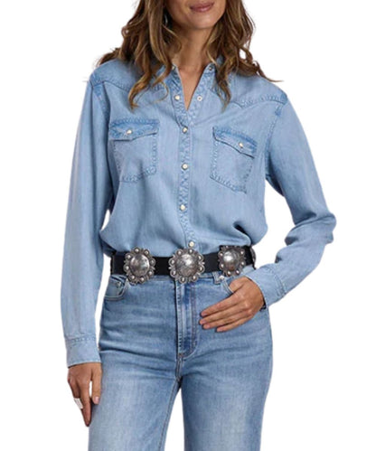 Front view of the women's light wash Stetson long sleeve denim snap shirt featuring the single point snap flap chest pockets, western yokes, spread collar, and snap cuffs