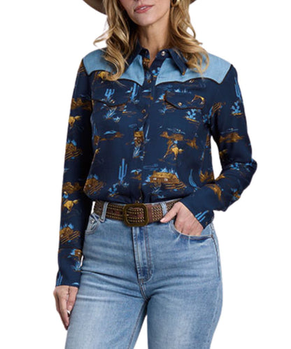 Front view of the women's blue Stetson long sleeve snap shirt featuring the light denim color blocked western yokes, chest pockets, and the ranch life western print