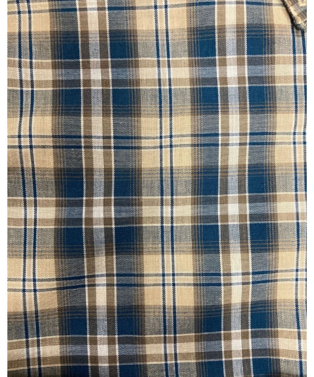 Close-Up View Of The Tan And Blue Plaid Print