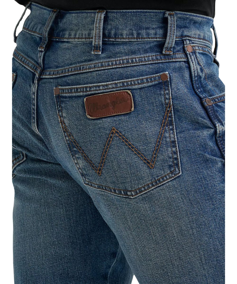 Close-up view of the back pockets featuring logo stitching and a worn leather logo patch 