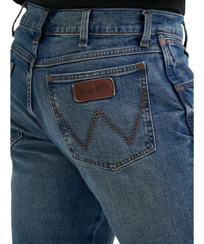 Close-up view of the back pockets featuring logo stitching and a worn leather logo patch 