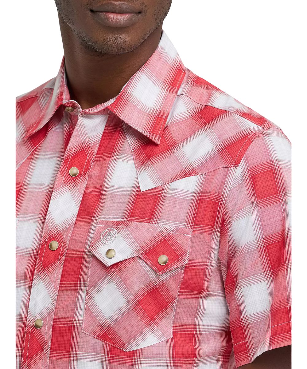 Close-up view of the men's plaid snap shirt featuring single point front yokes, a spread collar, and sawtooth snap flap chest pockets.