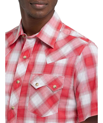 Close-up view of the men's plaid snap shirt featuring single point front yokes, a spread collar, and sawtooth snap flap chest pockets.
