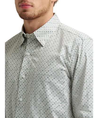 Close-up view of the green and tan cross print button down featuring a single open chest pocket and hidden button down collar.