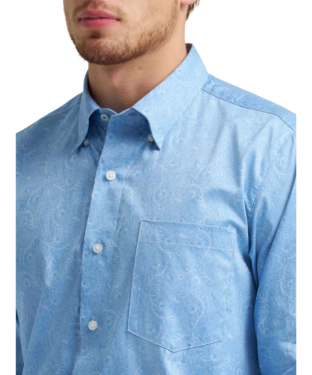 Close-up view of the dusty blue leaf print featuring a hidden button-down collar and single open chest pocket.