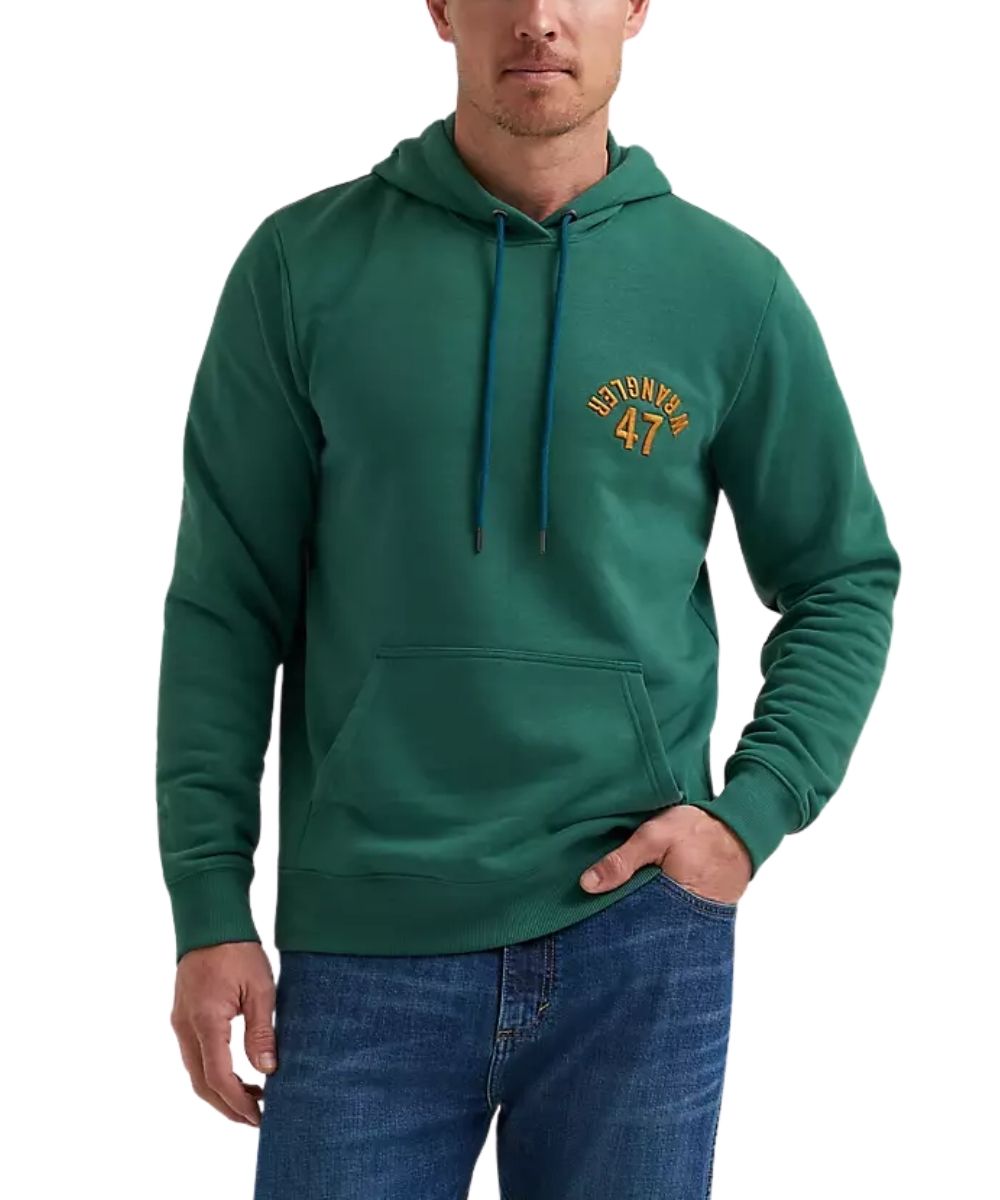 A man wearing a green pullover hoodie with a yellow and green 'WRANGLER 47' graphic on the left chest, paired with blue jeans, against a plain white background.