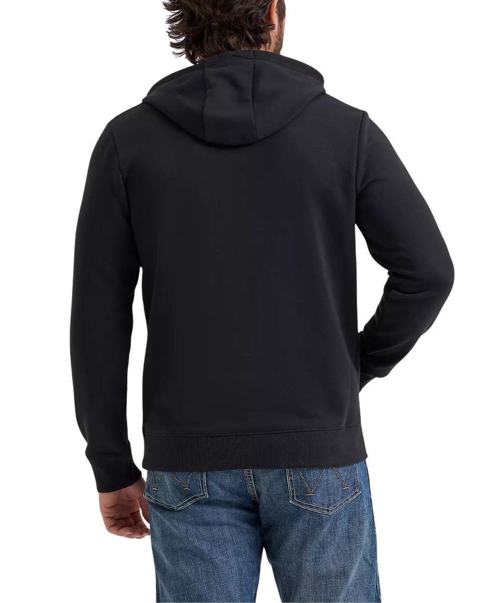 A man from behind wearing a black pullover hoodie paired with blue jeans against a plain white background.