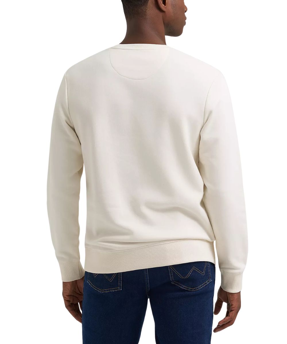 A man wearing an off-white crewneck sweatshirt, shown from the back, paired with dark blue jeans against a plain white background.