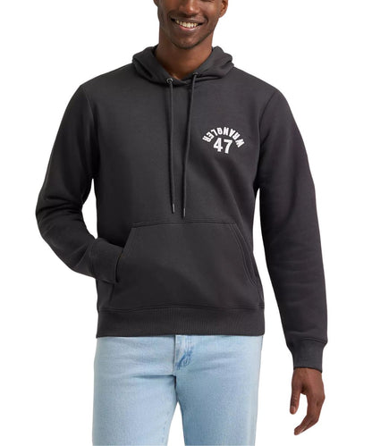 A man wearing a dark charcoal gray pullover hoodie with a white 'ESTONIA 47' graphic on the left chest, paired with light blue jeans, against a plain white background.