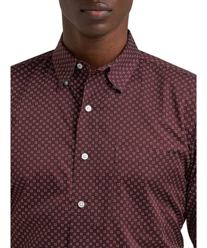 Close-up view of the single open chest pocket, hidden button down collar, and geo print
