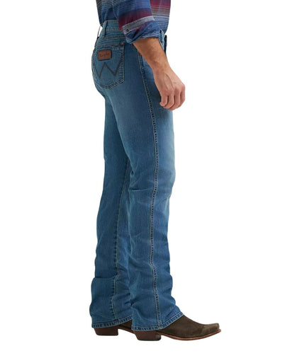 Side view of the men's retro relaxed boot cut jean featuring the mid rise and dark wash