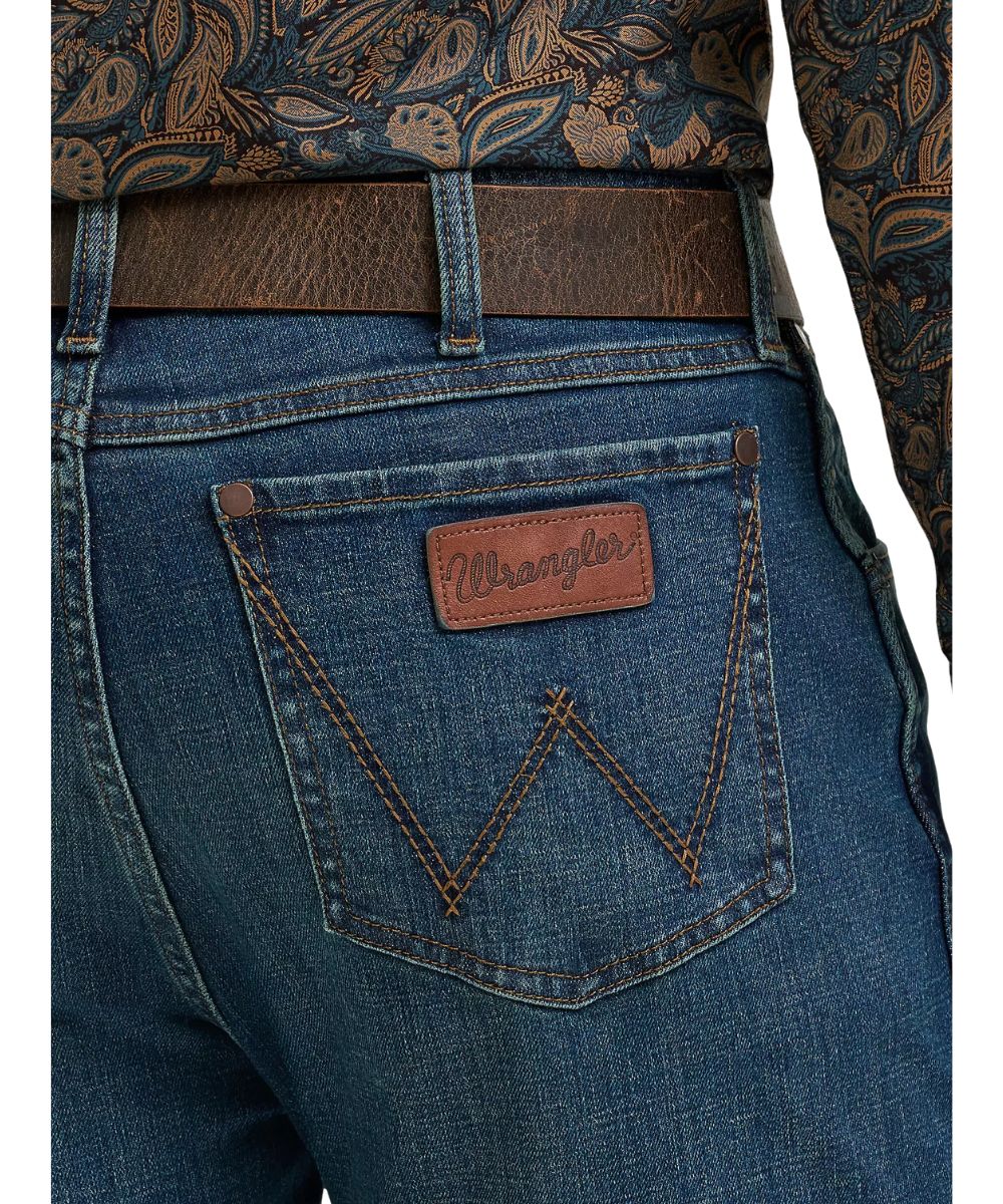 Close-up view of the logo stitched back pockets featuring a leather logo patch