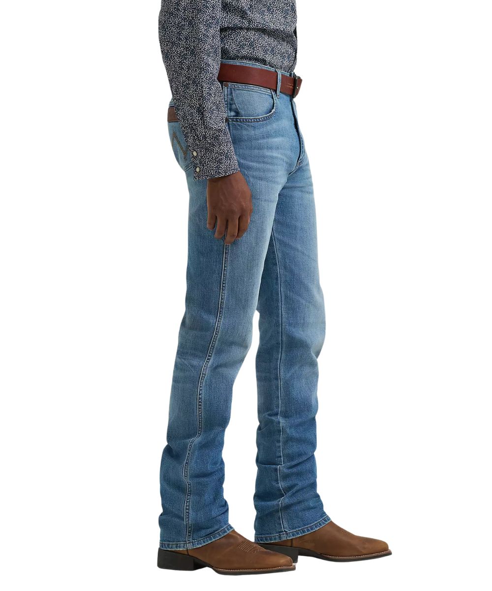 Side view of the men's medium wash slim straight jean featuring a low rise