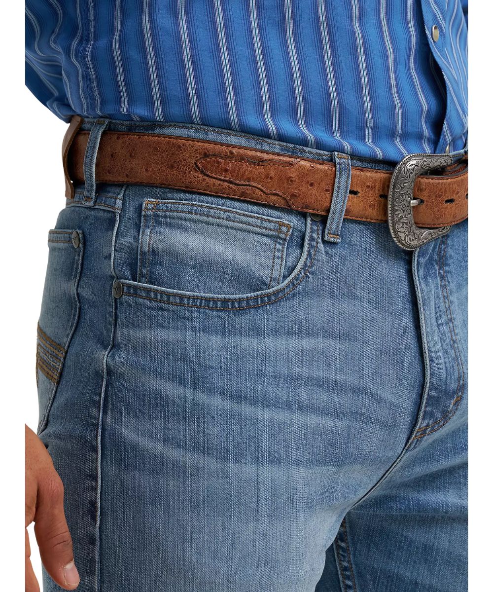 Close-up view of the front pockets featuring the five pocket styling, low rise, and distressed detailing