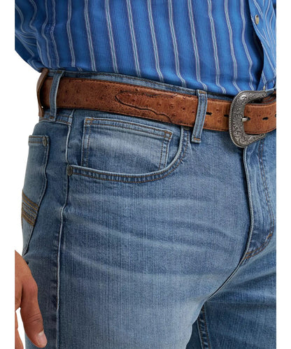 Close-up view of the front pockets featuring the five pocket styling, low rise, and distressed detailing