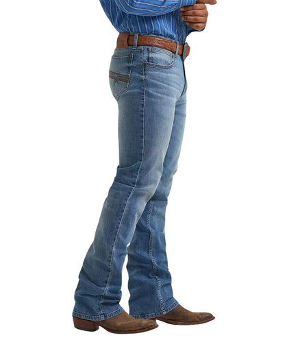 Side view of the men's medium wash jean featuring the vintage boot cut leg with an 18" leg opening