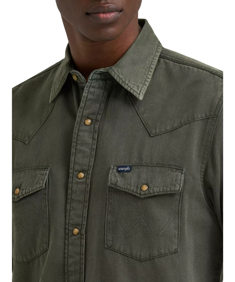 Close-up view of the solid print olive denim western snap shirt featuring the single point western yokes, spread collar, and single point snap flap chest pockets with logo stitching