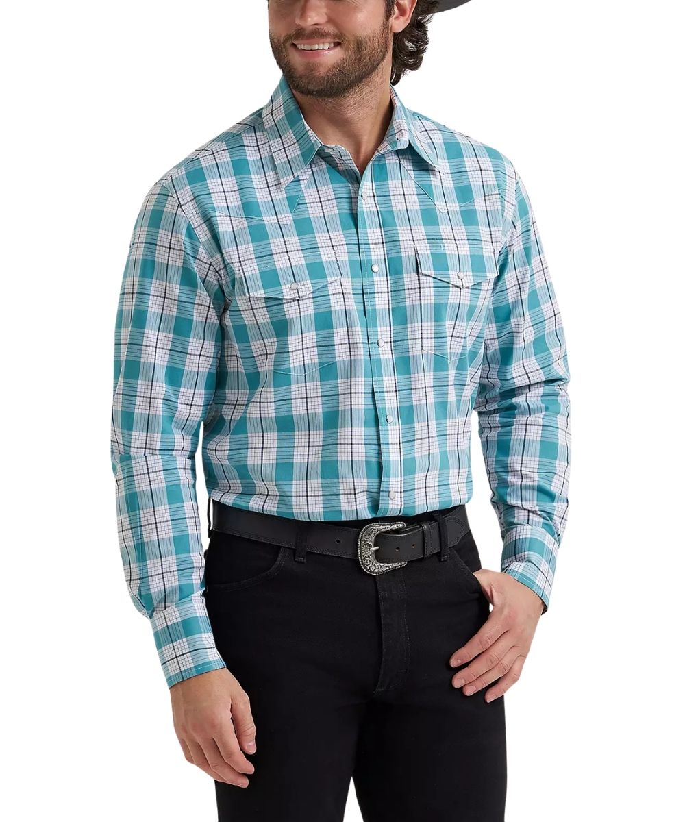 A man wearing a turquoise, white, and light blue plaid western long-sleeve button-down shirt, paired with black jeans and a black belt, against a plain white background.