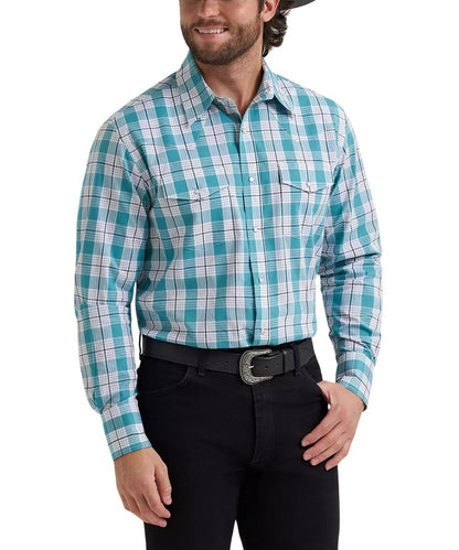 A man wearing a turquoise, white, and light blue plaid western long-sleeve button-down shirt, paired with black jeans and a black belt, against a plain white background.