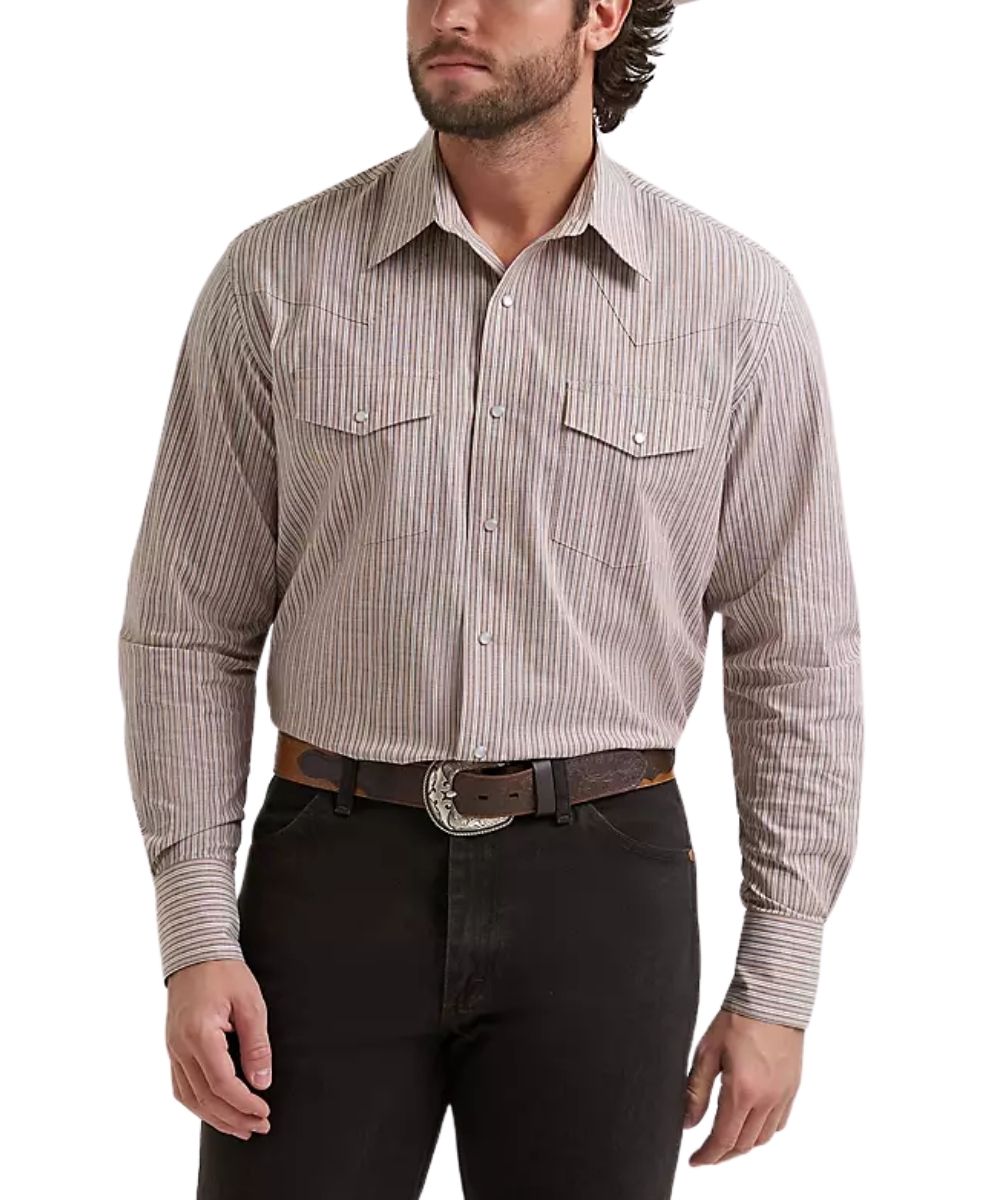 A man wearing a long-sleeve western-style button-up shirt with thin vertical stripes in beige and cinnamon, paired with black pants and a brown belt with a silver buckle, against a plain white background.