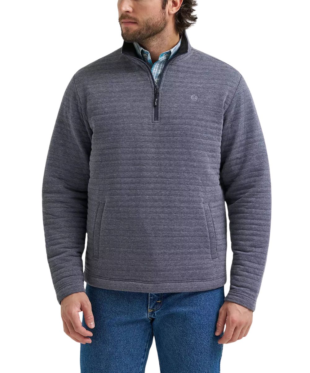 A man wearing a charcoal gray quarter-zip fleece pullover sweater with horizontal ribbed texture, paired with blue jeans and a patterned collared shirt underneath, shown against a plain white background.
