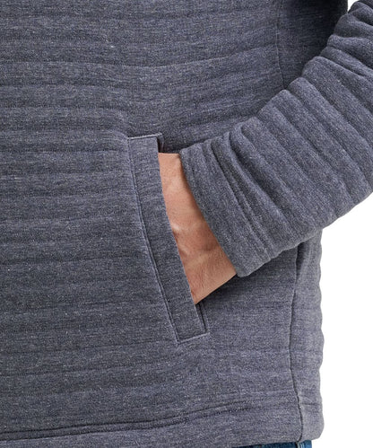 Close-up of a person wearing a dark heather gray ribbed knit hoodie with a side pocket, showing the sleeve cuff and hand in the pocket.