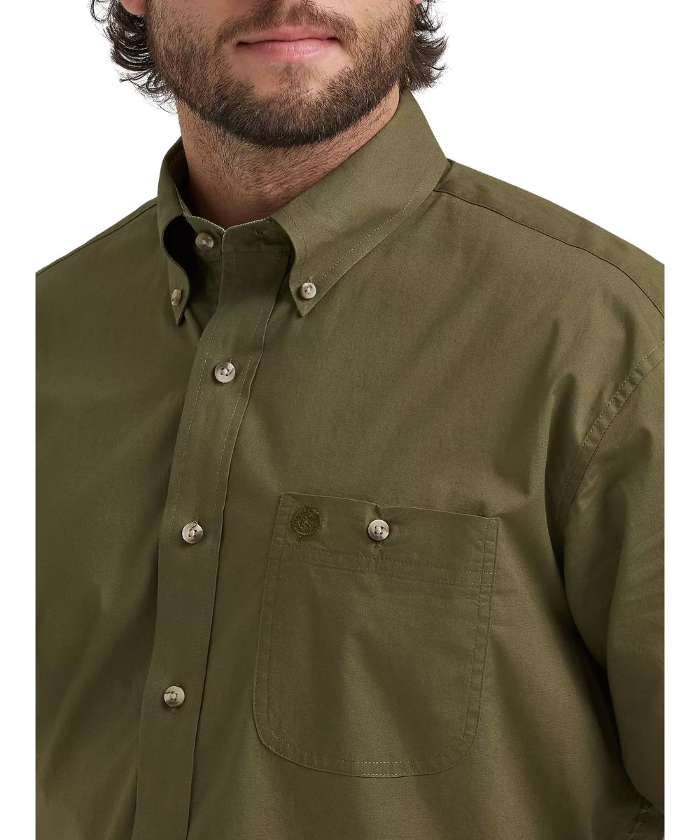 Close-up view of the men's green button down featuring the button-down collar, single button-through chest pocket, and the solid print