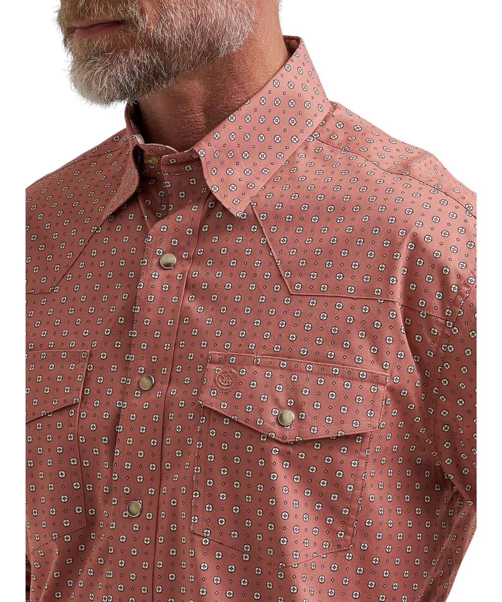 Close-up view of the adobe geo print, western yokes, single point snap flap chest pockets, and hidden button down collar