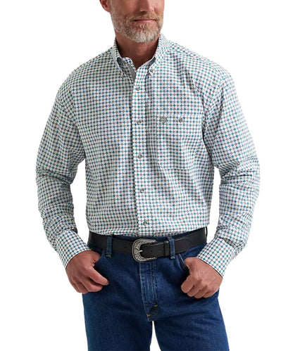 A man wearing a long-sleeve button-down western shirt with a small blue and white checkered pattern, paired with blue jeans and a black belt.