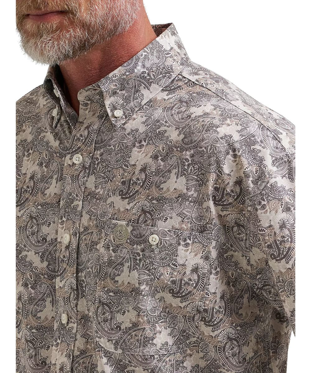 Close-up view of the single button-through chest pocket, the button down collar, and paisley print