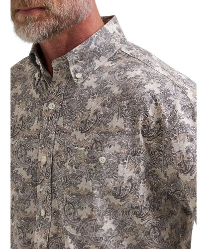 Close-up view of the single button-through chest pocket, the button down collar, and paisley print