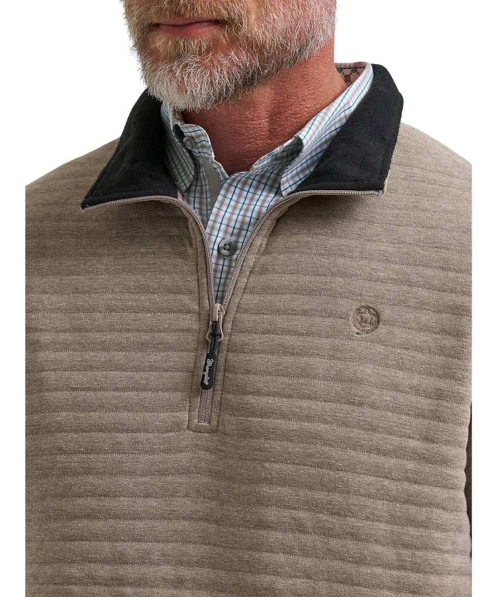 Close-up view of the contrast mock collar featuring the logo embroidery at the chest, and 1/4 zip closure