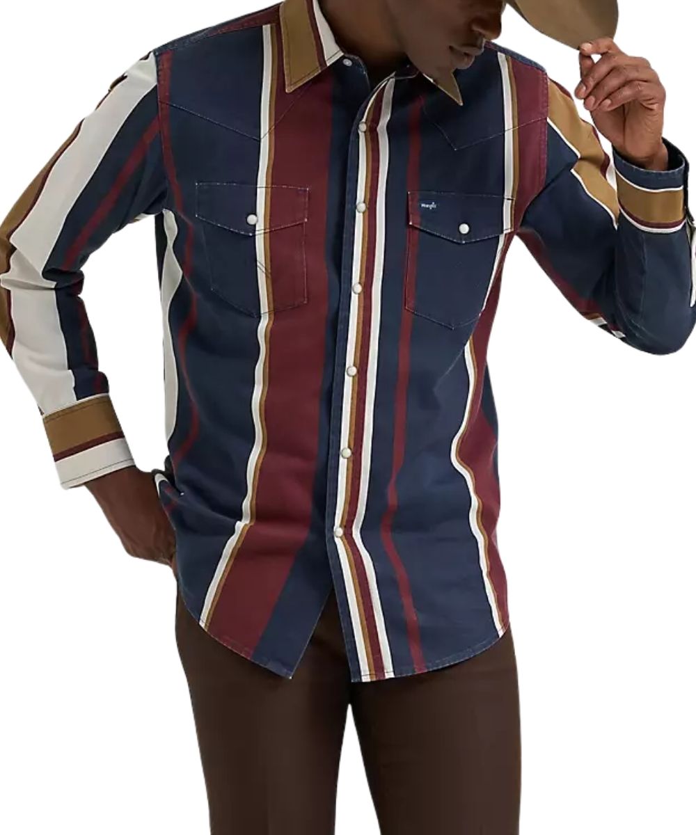 A man wearing a long-sleeve western-style button-up shirt with vertical stripes in navy blue, burgundy red, cream, and tan, paired with brown pants and a tan cowboy hat against a white background.