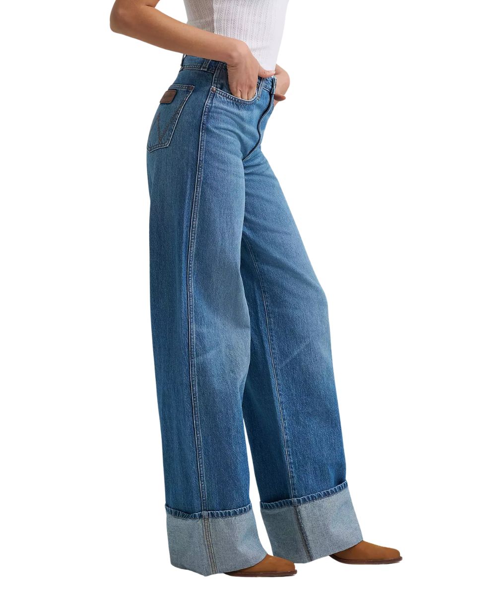 Side view of the women's wide leg jean featuring large turned cuffs at the hems