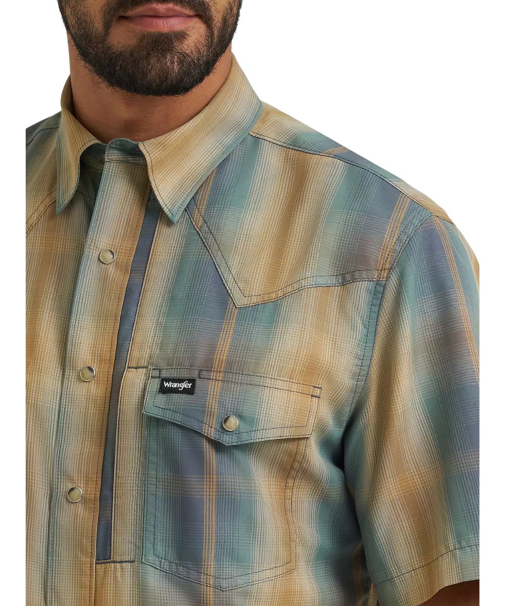 Close-up view of the turbulence ombre plaid print, hidden snap down collar, and chest pockets