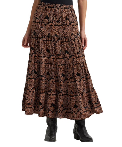 A tiered maxi skirt with an intricate brown and black paisley pattern, worn by a model with black ankle boots against a plain white background.