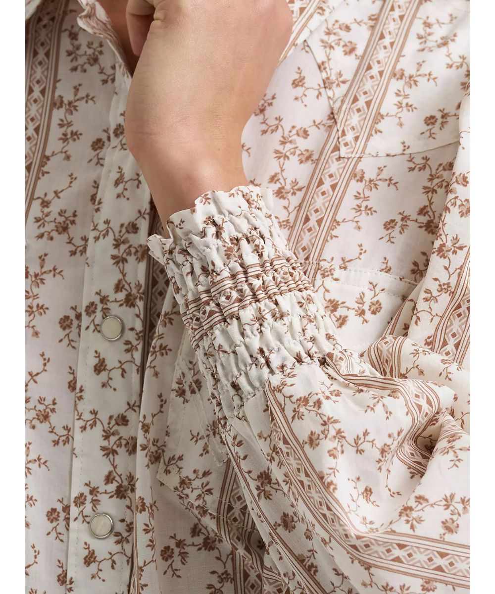 Close-up view of the floral print featuring the elastic smocked cuffs, western yokes, and single point snap flap chest pockets