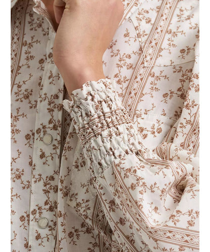 Close-up view of the floral print featuring the elastic smocked cuffs, western yokes, and single point snap flap chest pockets