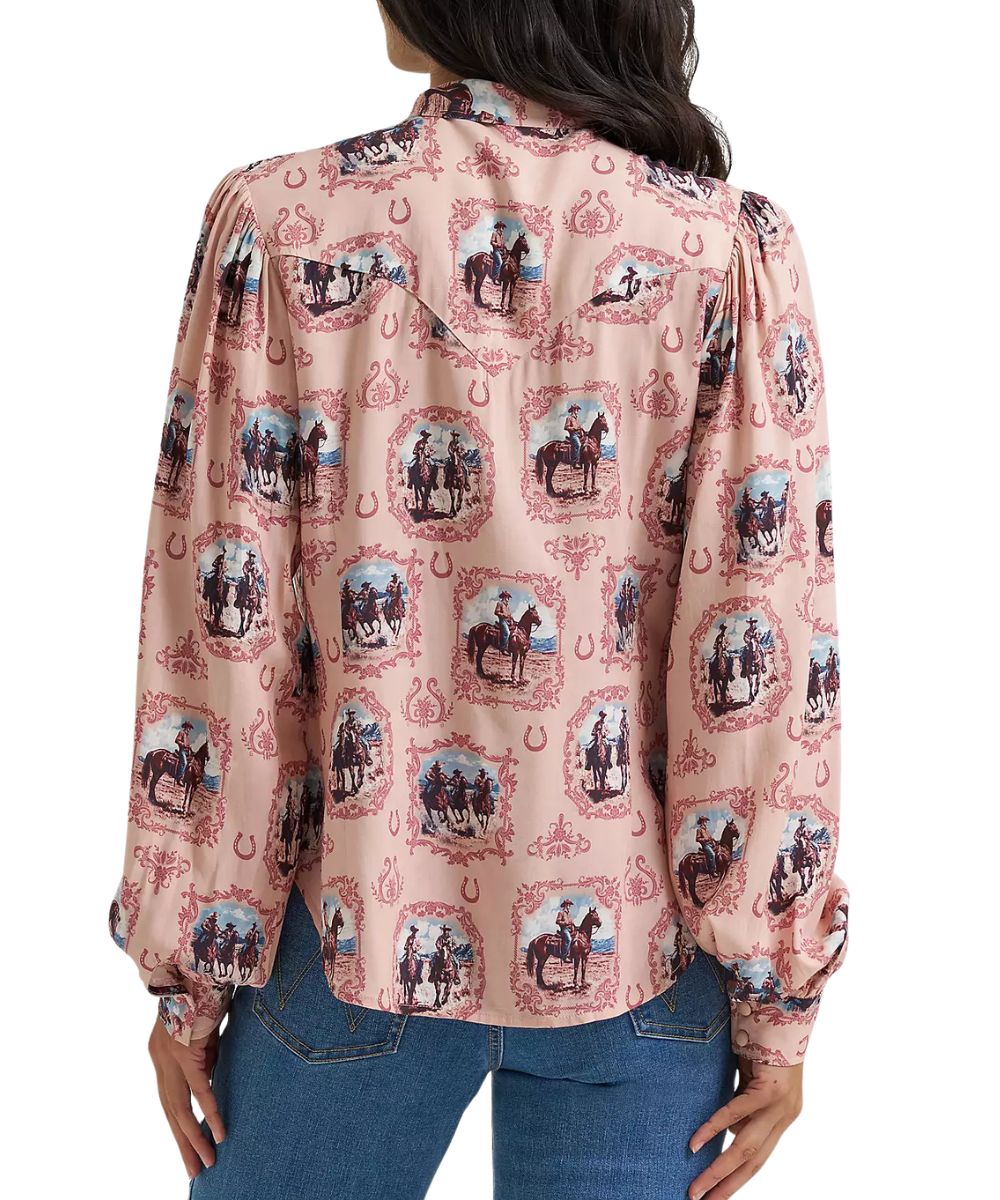 Back view of the women's pink blouse featuring the single point western yoke on the back and button cuffs and the long balloon puff sleeves