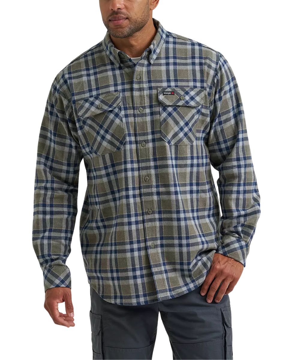 A man wearing a long-sleeve plaid button-up shirt in olive green, blue, and gray, paired with dark gray cargo pants, against a plain white background.