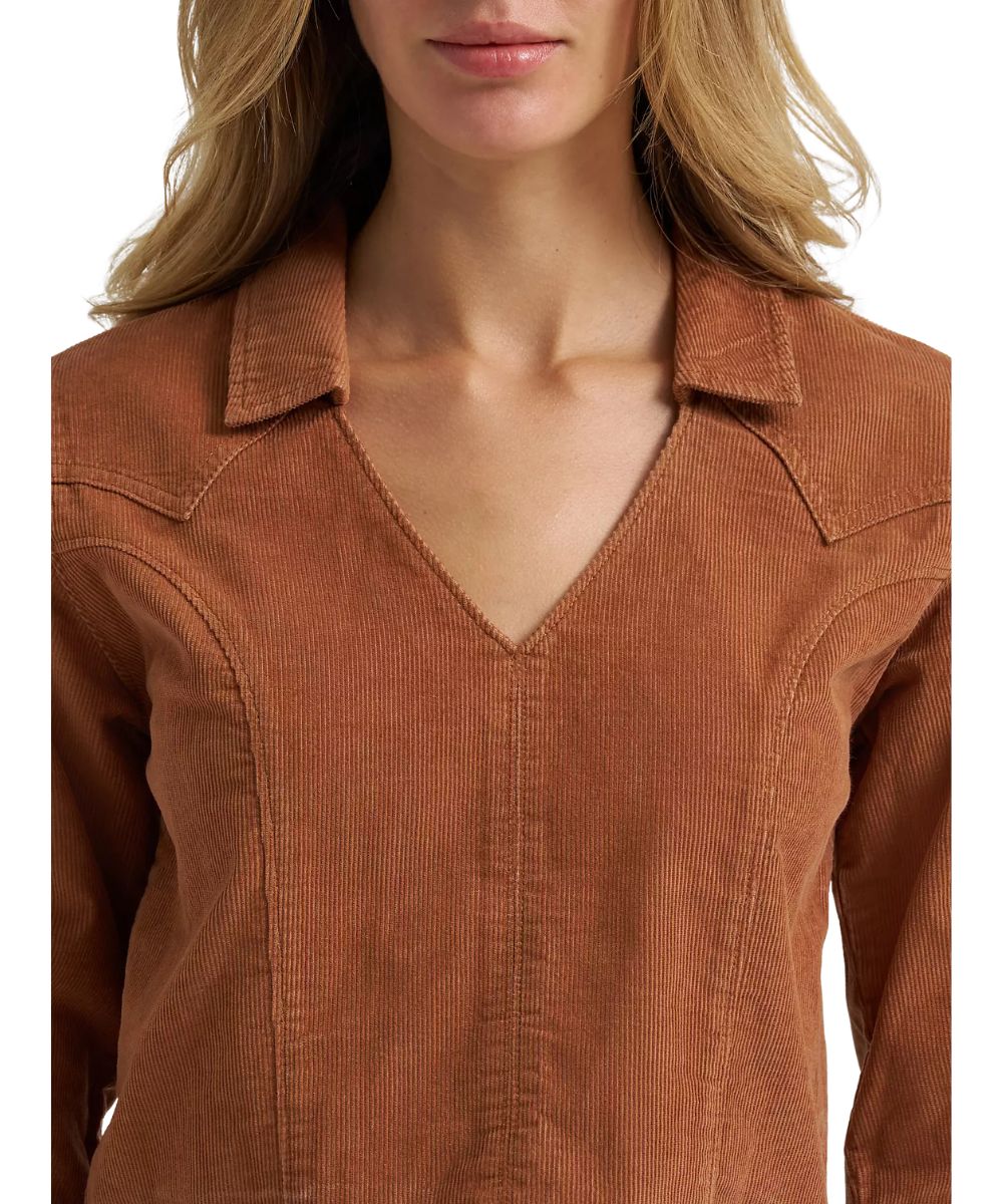Close-up fabric view of the solid printed brown corduroy shirt featuring the v-neckline with a spread collar, seam detailing, and western yokes