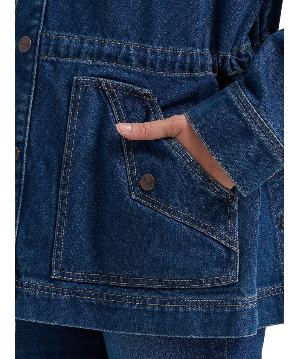 Close-up view of the angled hand pockets with western yoke detailing and a faux button 