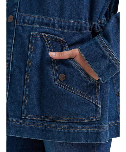 Close-up view of the angled hand pockets with western yoke detailing and a faux button 