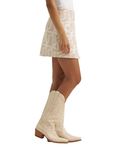Side view of the women's white mini skirt featuring a length of approximately 17"