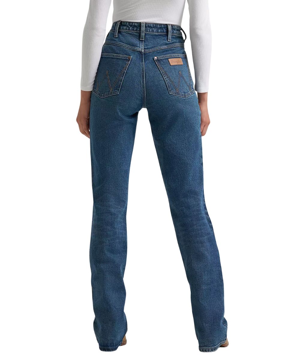 Back view of the women's medium wash boot cut jean featuring the super high rise and fitted construction through the seat and thigh