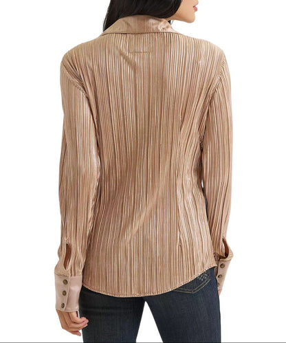A woman shown from the back wearing a long-sleeve collared blouse with vertical pleats in a warm beige and brown tone, paired with dark jeans against a plain white background.